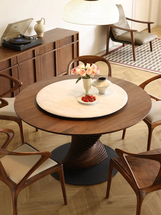 High-angle view of The Helios Round Dining Table showcasing the convenient integrated white marble Lazy Susan, surrounded by mid-century modern dining chairs.