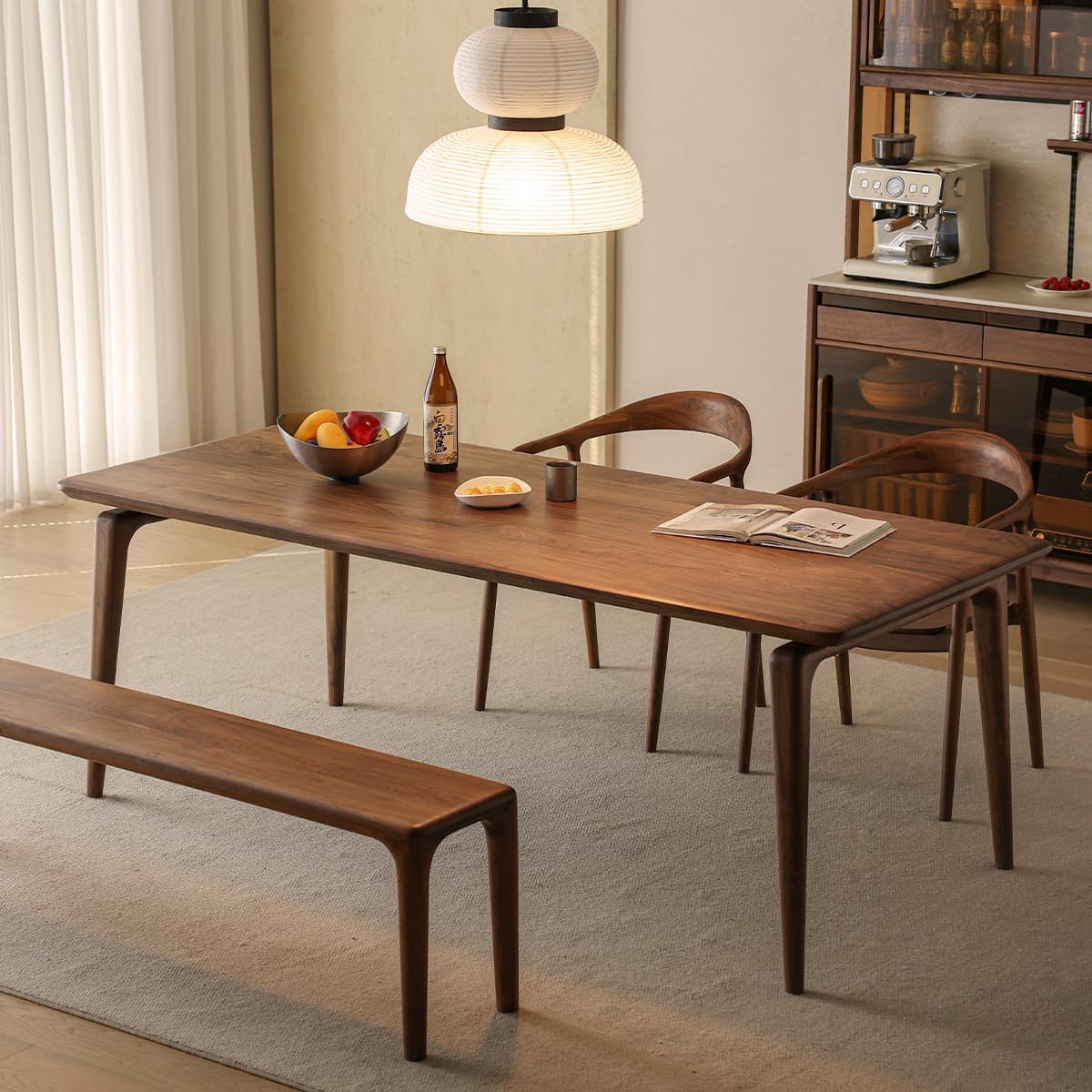 Walnutry Helios collection North American black walnut dining table used as a spacious home office desk with a matching bench, showcasing a modern minimalist design.