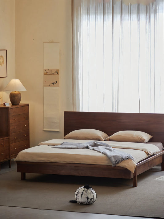 A complete Walnutry bedroom collection featuring The Helios solid wood platform bed and a matching North American Black Walnut tallboy dresser.