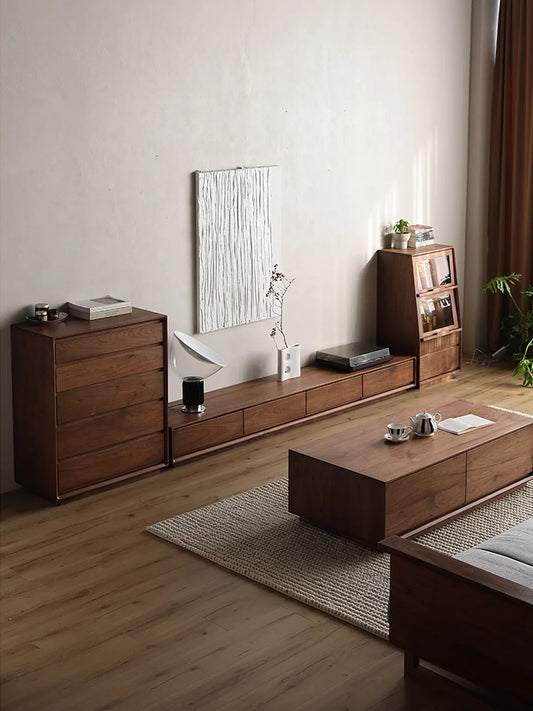 The Heritage 5-Drawer Tallboy in North American Black Walnut styled in a modern living room alongside matching Walnutry furniture.