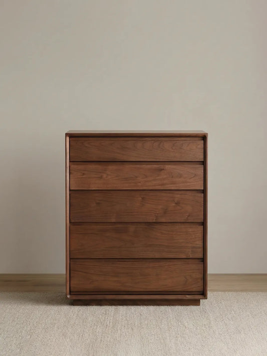 Straight-on studio view of The Heritage 5-Drawer Tallboy showcasing the minimalist design and rich North American Black Walnut finish.