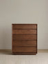 Straight-on studio view of The Heritage 5-Drawer Tallboy showcasing the minimalist design and rich North American Black Walnut finish.