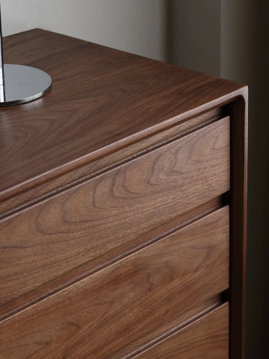 Detail shot of the smooth rounded top corner and beautiful continuous wood grain on The Heritage 5-Drawer Tallboy.