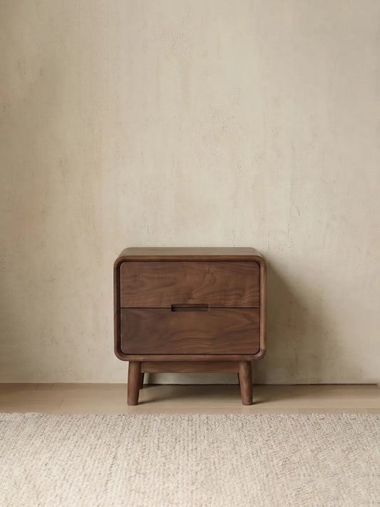 Clean front view of the Heritage black walnut nightstand, showcasing its integrated drawer pulls and elegant tapered legs.