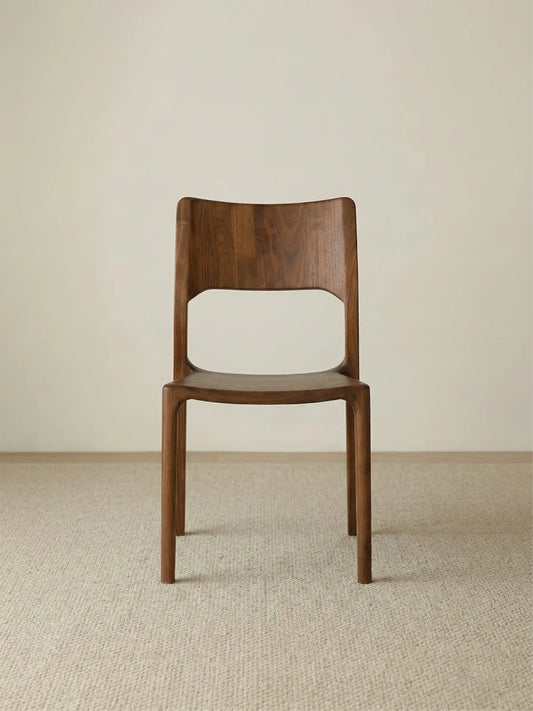 Clean, straight-on studio front view of The Heritage Dining Chair, showcasing its all-wood mid-century design and rich walnut finish.