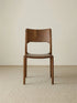 Clean, straight-on studio front view of The Heritage Dining Chair, showcasing its all-wood mid-century design and rich walnut finish.