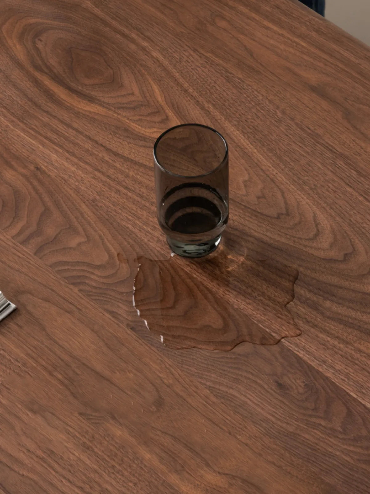Close-up of water droplets on the table surface, demonstrating the durable water-resistant wood wax oil finish.