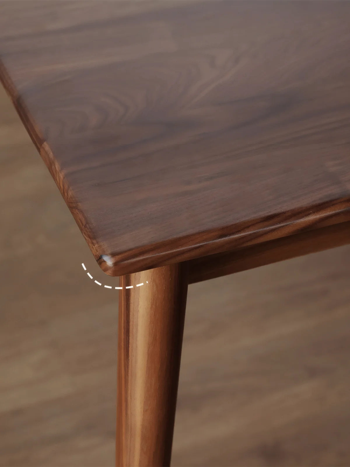 Rounded corner and tapered leg detail of the solid walnut extendable dining table