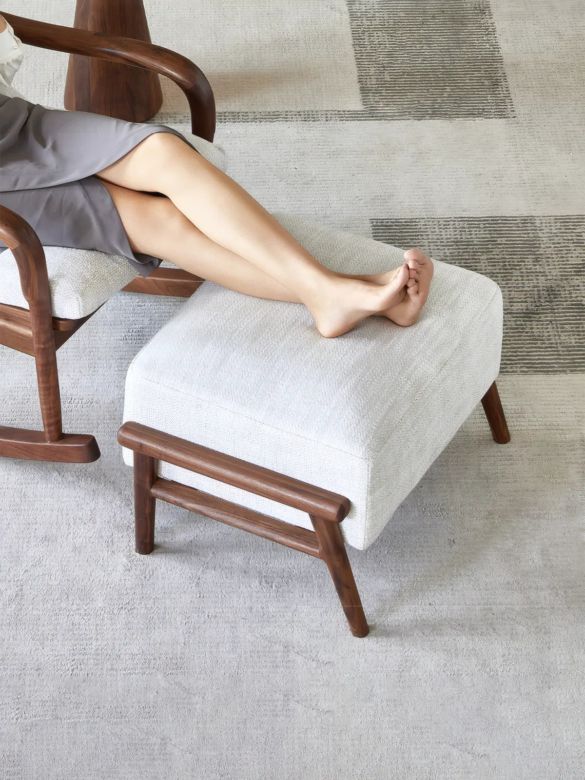 Walnutry Heritage Footstool used with lounge chair, comfortable fabric footstool for resting legs in a modern living room