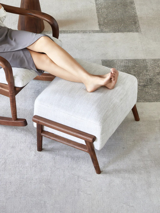 Walnutry Heritage Footstool used with lounge chair, comfortable fabric footstool for resting legs in a modern living room