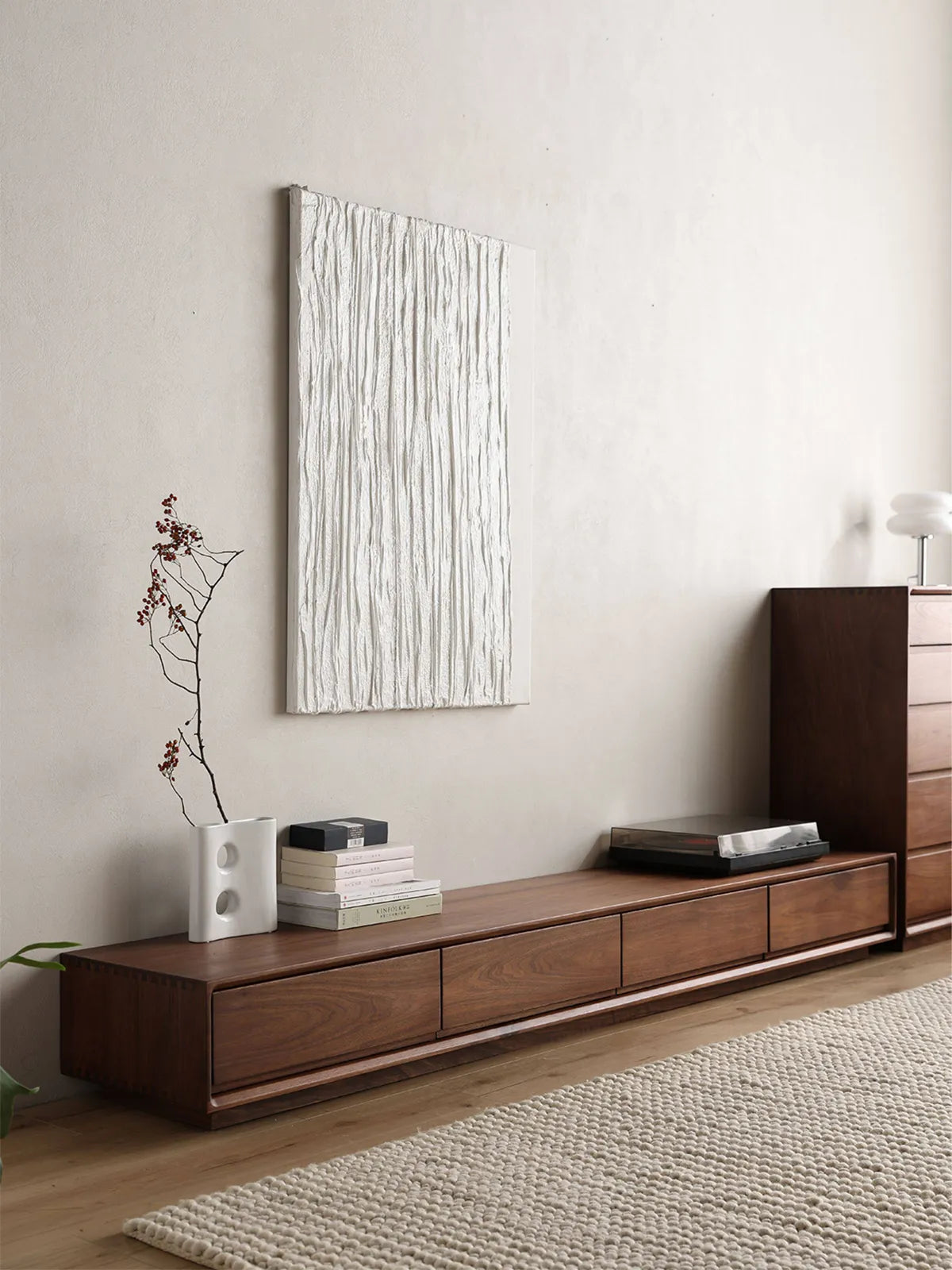 Angled view of the low-profile Heritage TV stand crafted from North American Black Walnut, showing its sleek and modern design.
