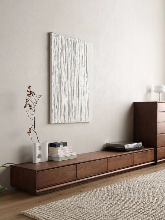 Angled view of the low-profile Heritage TV stand crafted from North American Black Walnut, showing its sleek and modern design.