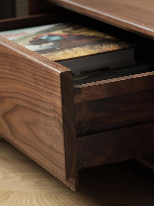 Close-up of a partially open drawer on The Heritage Media Console, revealing spacious internal storage for books and media accessories.