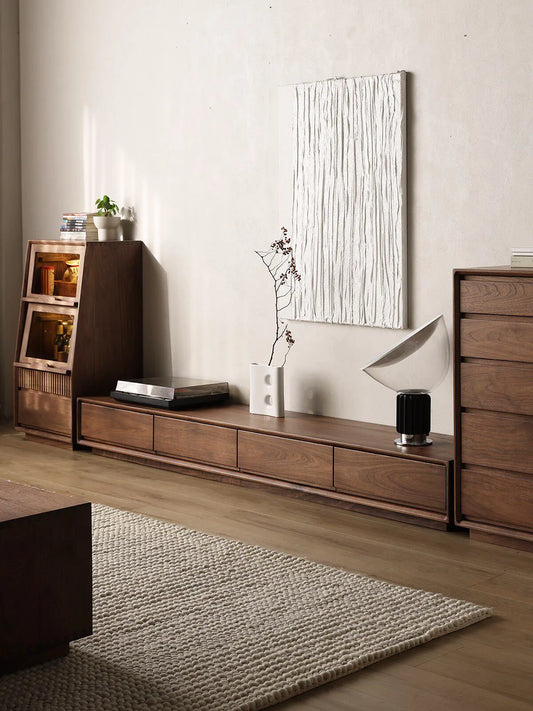 The Heritage Media Console perfectly paired with matching Walnutry solid wood storage cabinets and dressers in a cozy home setting.