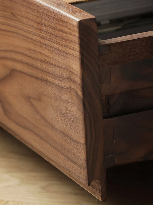Detail shot highlighting the solid walnut edge profiling and smooth sliding drawer craftsmanship of The Heritage Media Console.