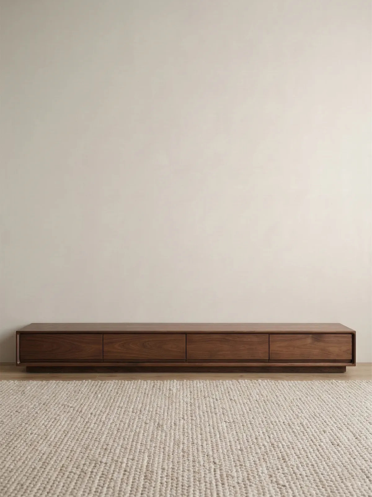 Clean front studio view of the modern, low-profile Heritage Media Console showcasing its balanced four-drawer symmetry and rich walnut finish.