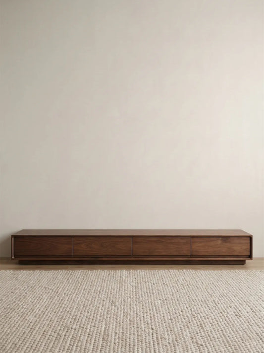 Clean front studio view of the modern, low-profile Heritage Media Console showcasing its balanced four-drawer symmetry and rich walnut finish.