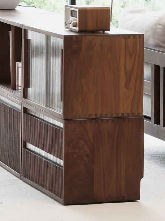 Side profile of stacked Heritage modular cabinet units, highlighting the traditional dovetail joinery and the rich, natural grain of solid black walnut wood.