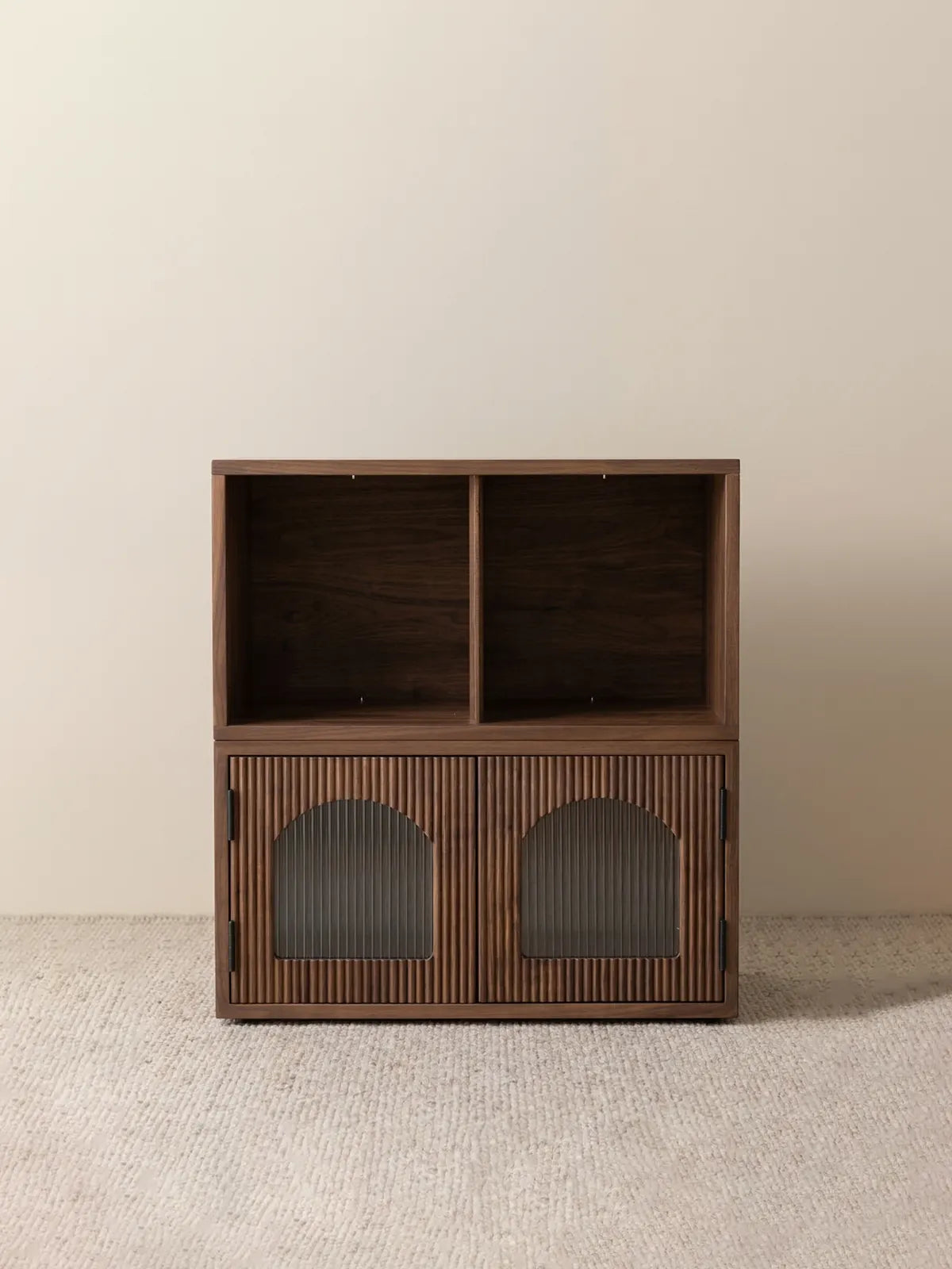 A freestanding two-tier setup of the Heritage modular solid walnut bookcase with doors, featuring twin open top cubbies and fluted glass lower sections.