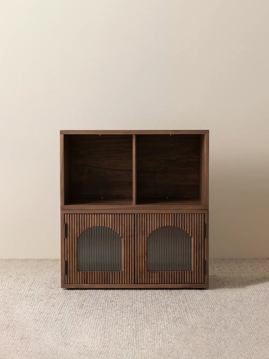 A freestanding two-tier setup of the Heritage modular solid walnut bookcase with doors, featuring twin open top cubbies and fluted glass lower sections.