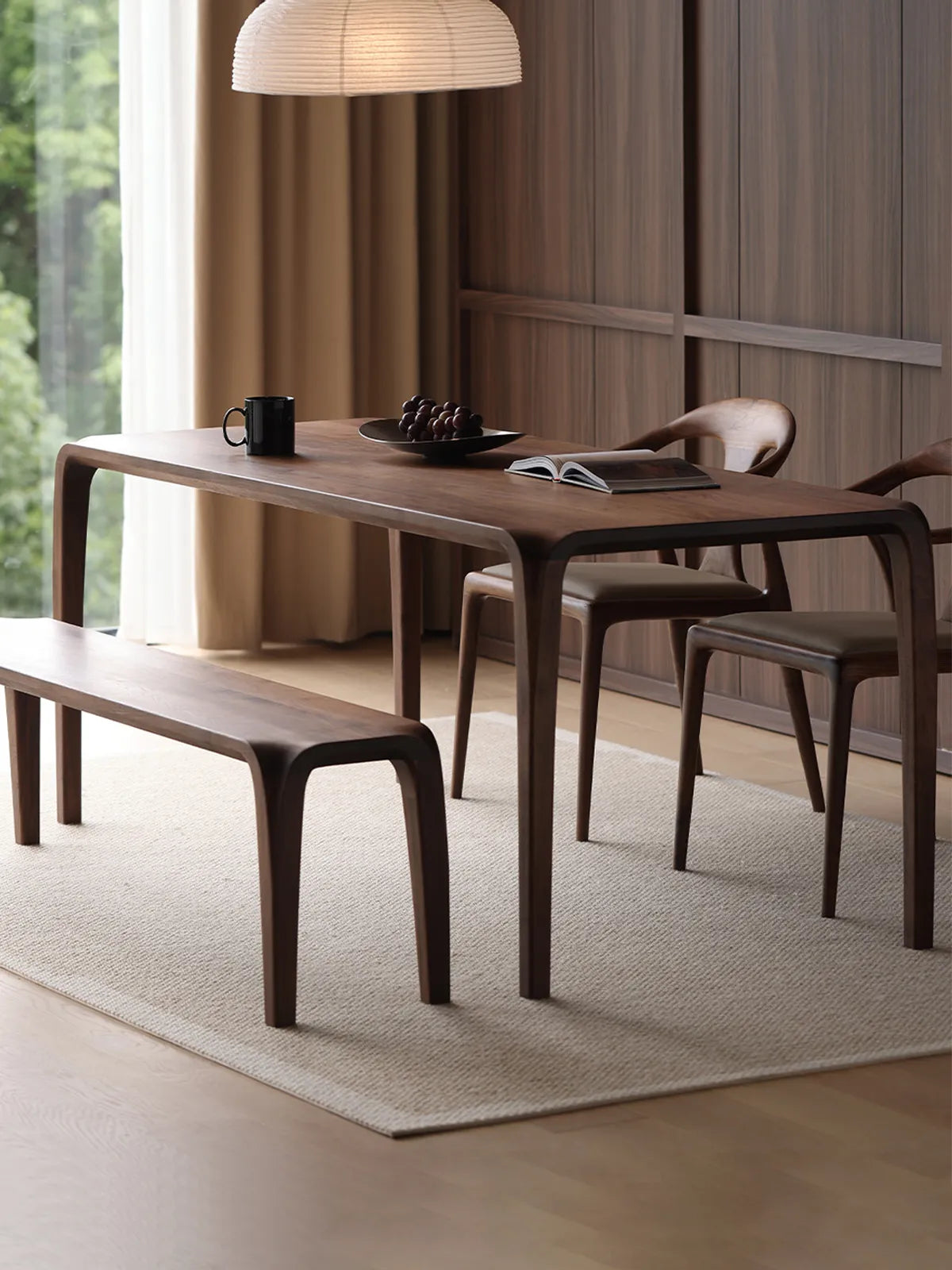 A complete dining room set featuring the rectangular mid century modern dining table paired with a matching walnut bench.