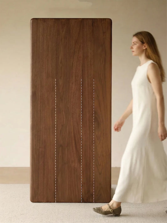 Top view of the solid walnut dining table showcasing premium, full-length continuous wood grain planks without joints.