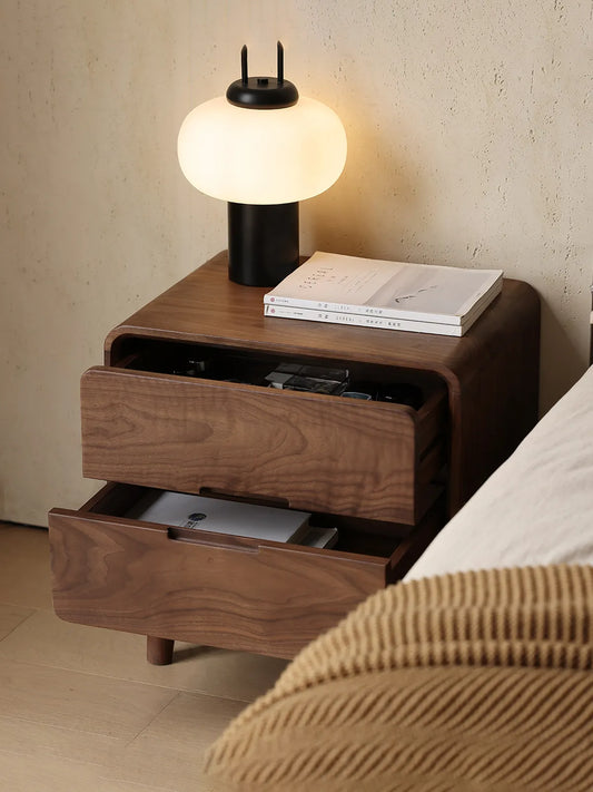 The Heritage walnut nightstand with drawers shown partially open, revealing traditional English dovetail joinery and spacious storage.