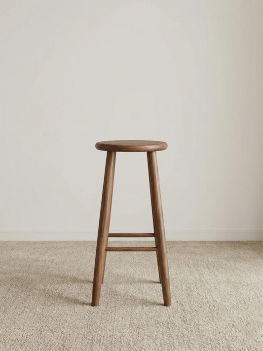 Walnutry Heritage Walnut Stool front view, solid wood counter height stool with round seat, tapered legs, and warm walnut grain for mid century modern kitchen seating