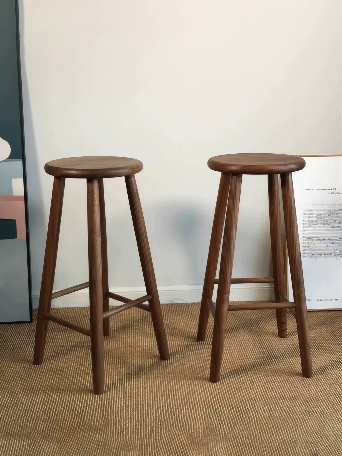 Walnutry Heritage Walnut Stool pair display, two solid wood stools with round seats and tapered legs styled as vintage mid century bar stools