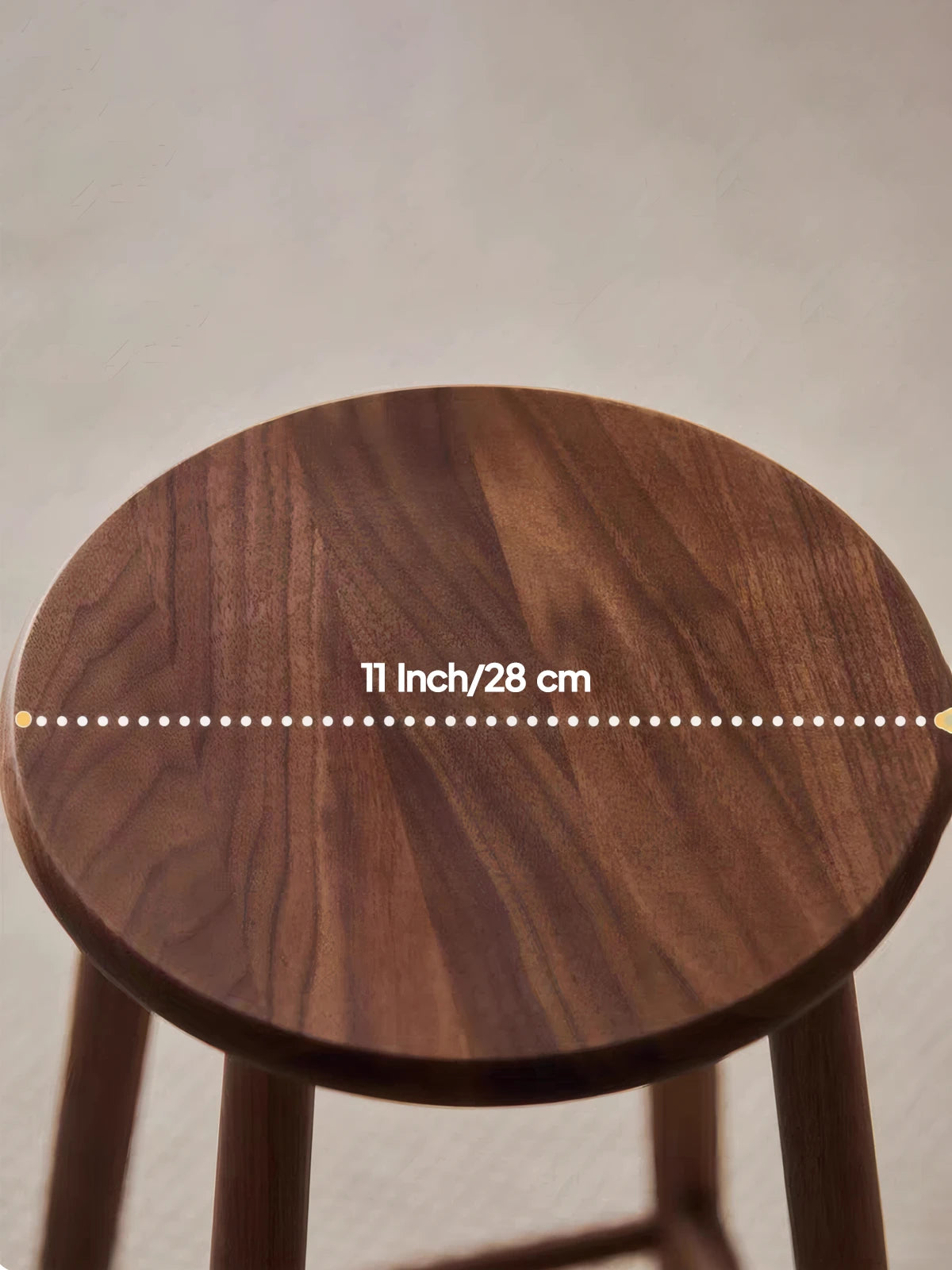 Walnutry Heritage Walnut Stool close-up of 11 inch round walnut seat, showing rich wood grain and smooth solid wood craftsmanship