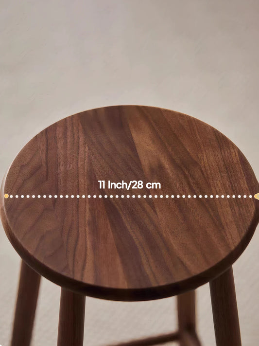 Walnutry Heritage Walnut Stool close-up of 11 inch round walnut seat, showing rich wood grain and smooth solid wood craftsmanship
