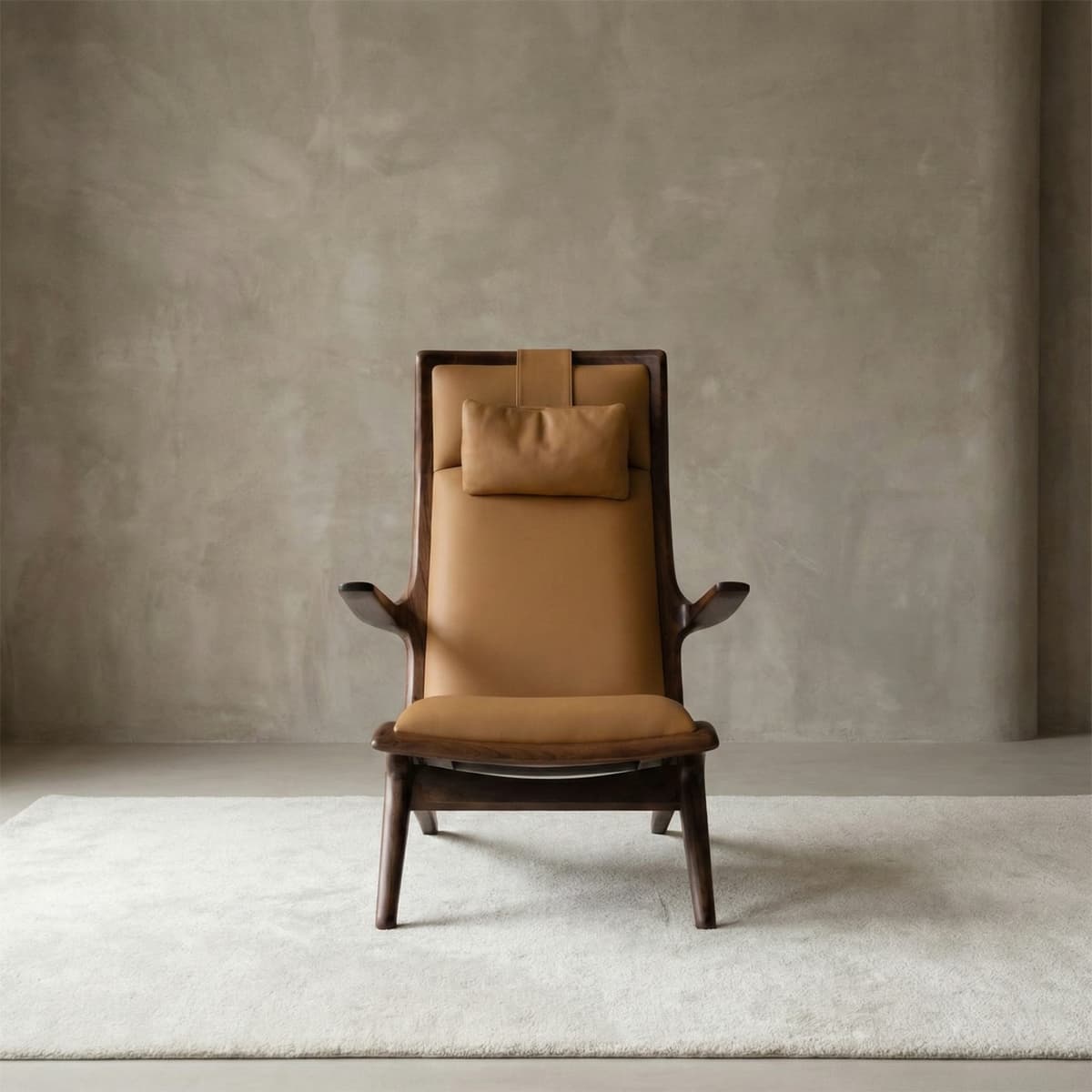 Sculptural high-back lounge chair in tan genuine leather with a headrest pillow, featuring a unique architectural solid walnut frame.