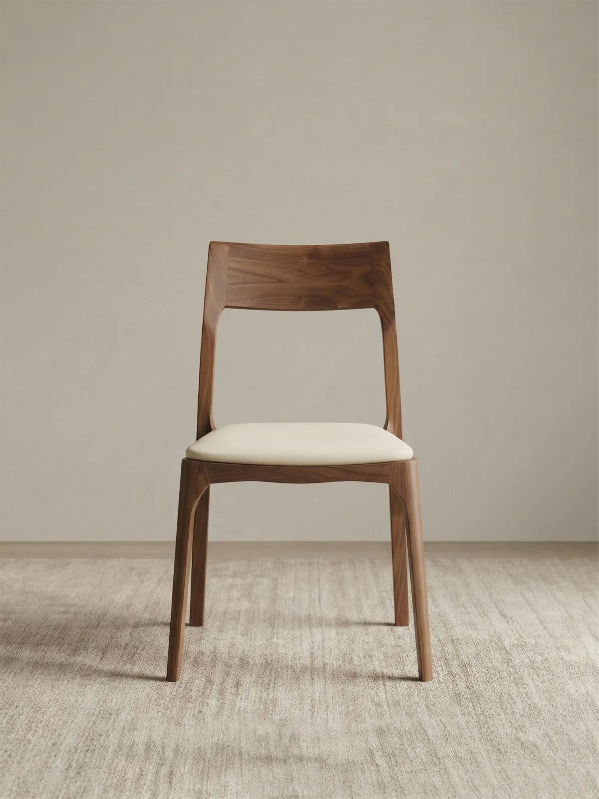 Clean, straight-on studio front view of the Walnutry Japandi solid walnut dining chairs, emphasizing its balanced symmetry and minimalist aesthetic.