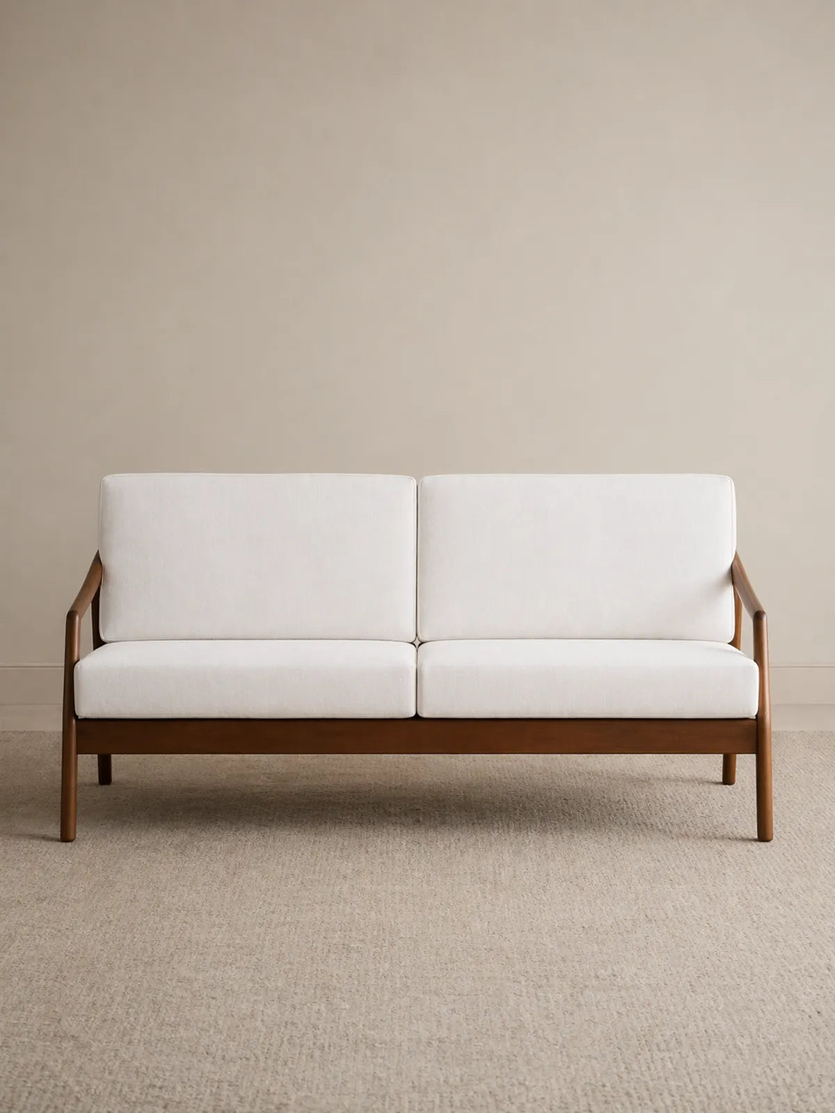 Keal single armchair front view in solid American black walnut with cream upholstered seat and back cushions (3-Seater)