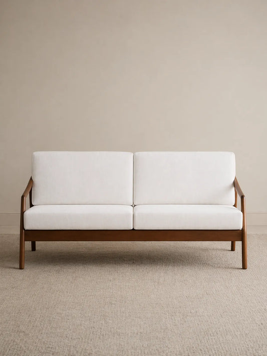 Keal single armchair front view in solid American black walnut with cream upholstered seat and back cushions (3-Seater)