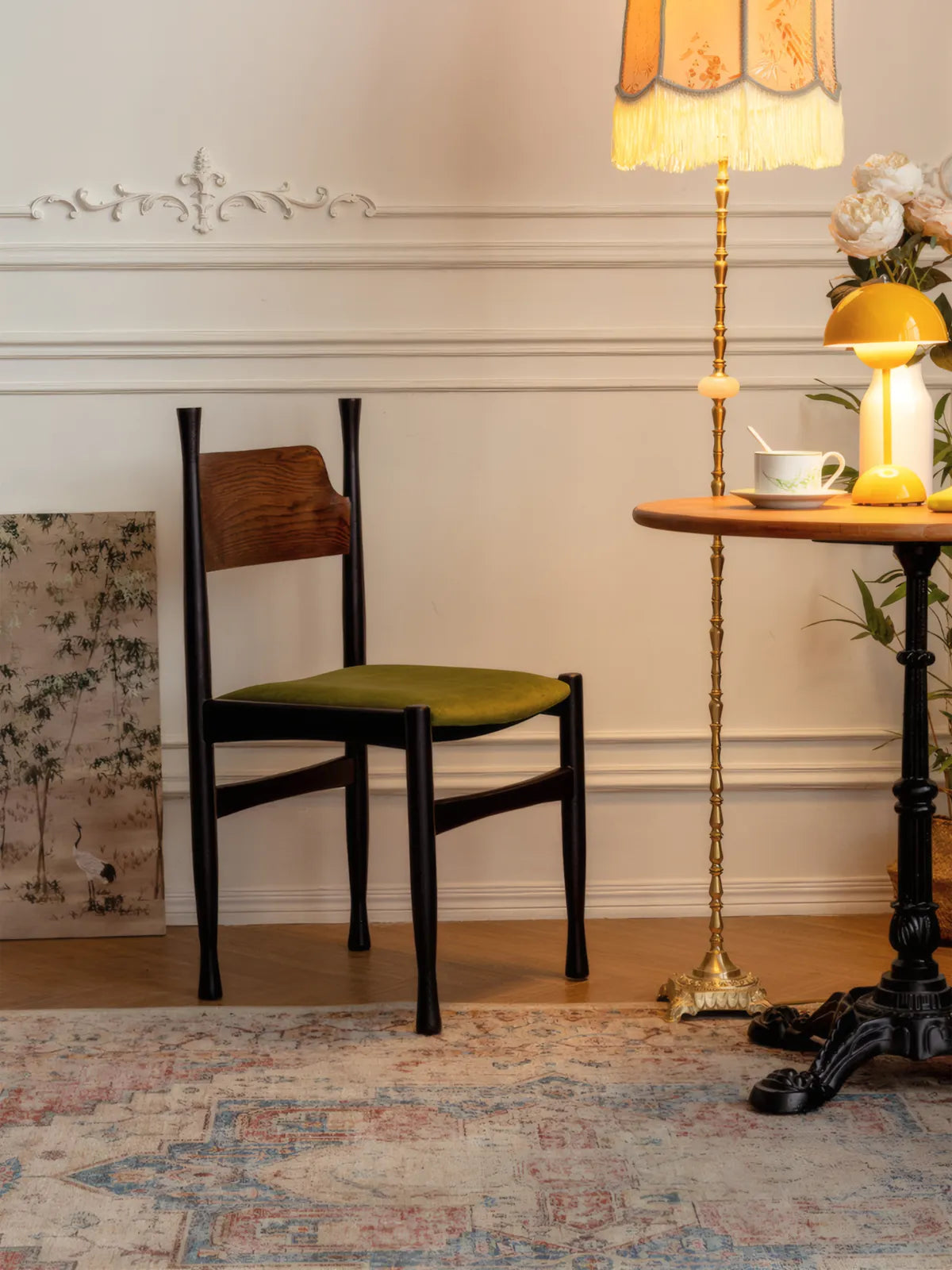 Korin dining chair three-quarter view in a styled interior with floor lamp and round side table
