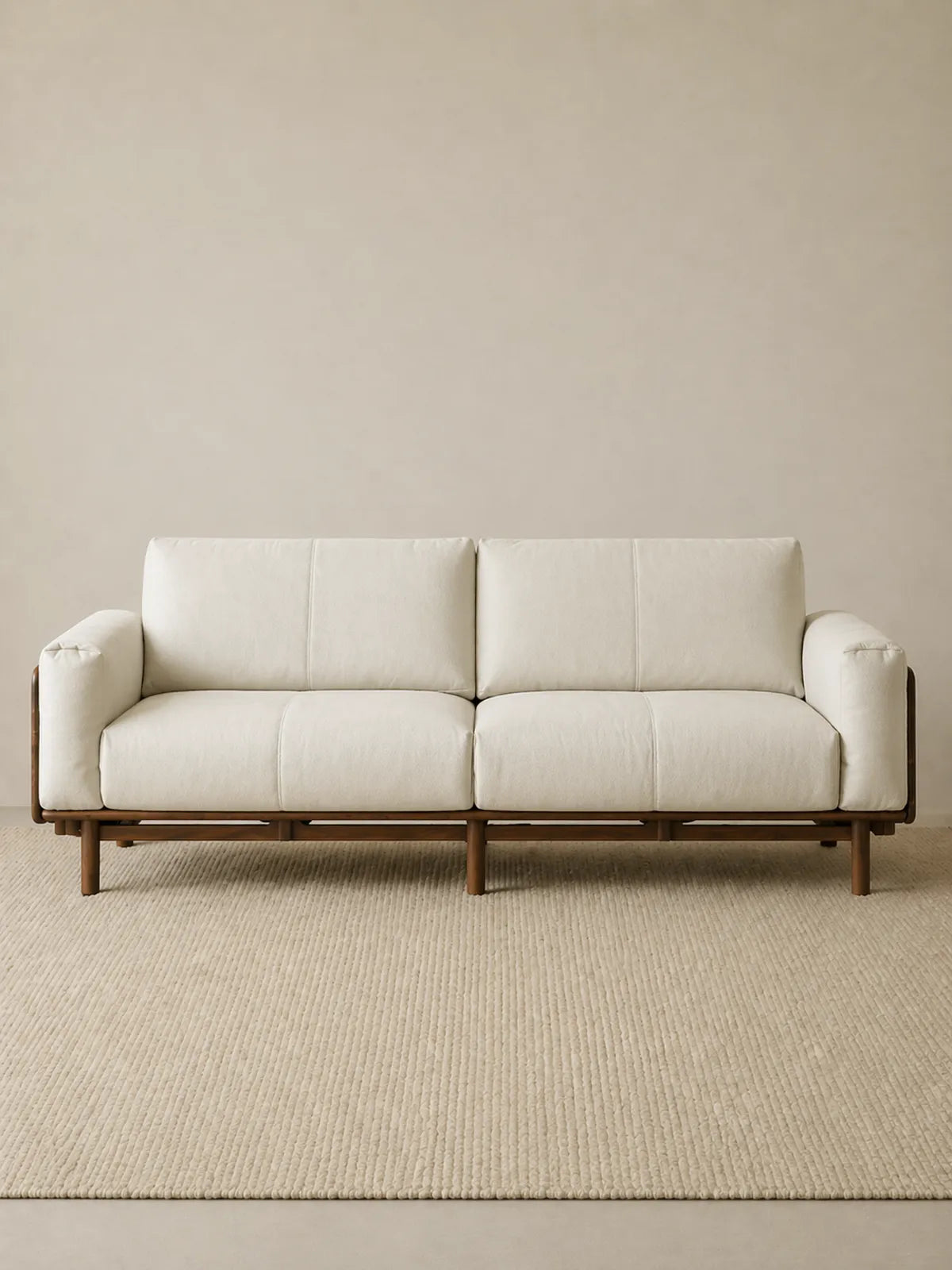 Lior three-seat sofa in white fabric upholstery with solid American black walnut frame, front view (White)