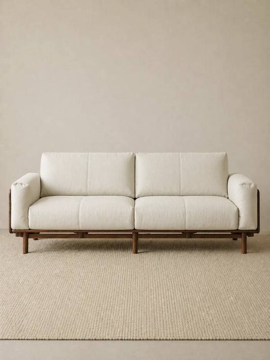 Lior three-seat sofa in white fabric upholstery with solid American black walnut frame, front view (White)