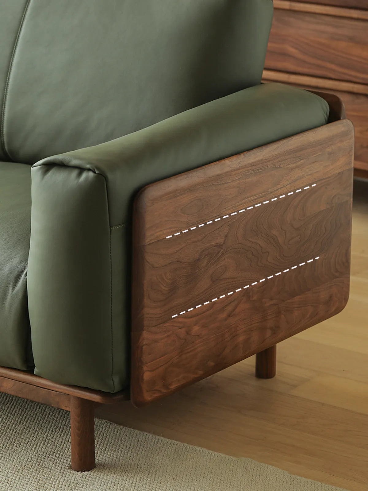 Close-up of Lior sofa walnut arm panel showing dramatic natural grain pattern on solid American black walnut