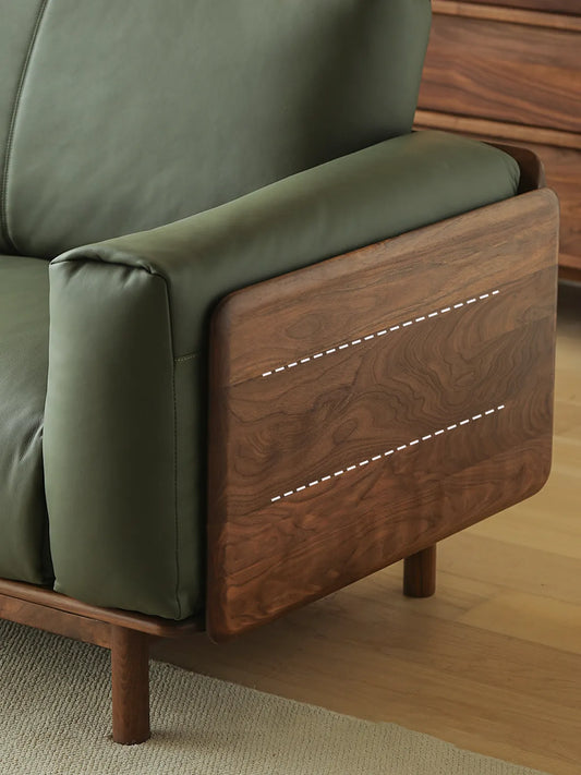 Close-up of Lior sofa walnut arm panel showing dramatic natural grain pattern on solid American black walnut