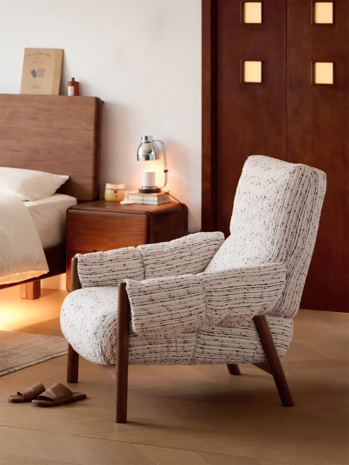 Walnutry Marais Armchair bedroom side lifestyle scene, wood and fabric armchair styled beside bed with warm lighting and relaxed modern atmosphere