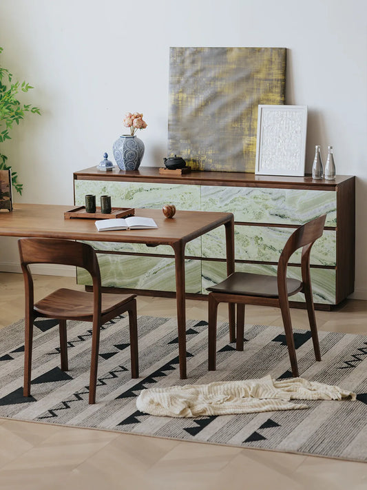 Overhead angled view of two Maren chairs tucked under a walnut dining table showing curved backrests and sculpted seats