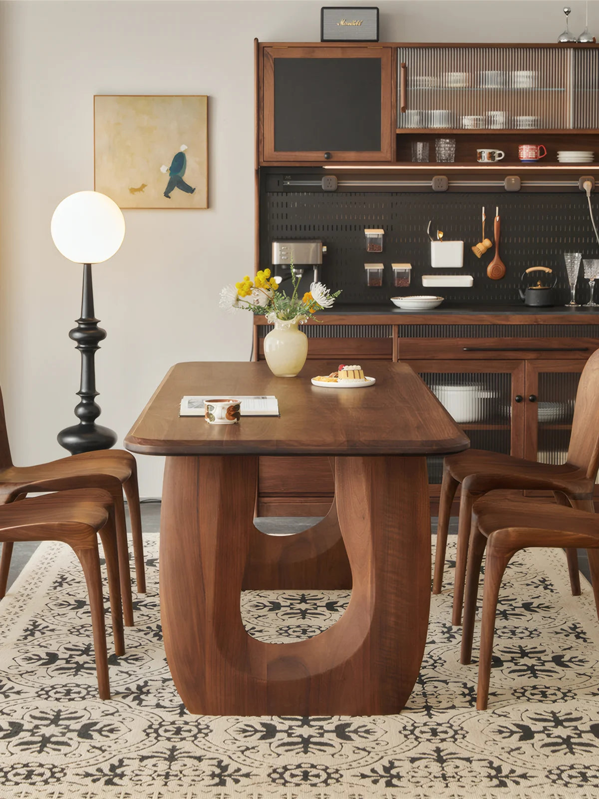 Front view of the Marlow double pedestal dining table styled with walnut chairs in a warm dining room.