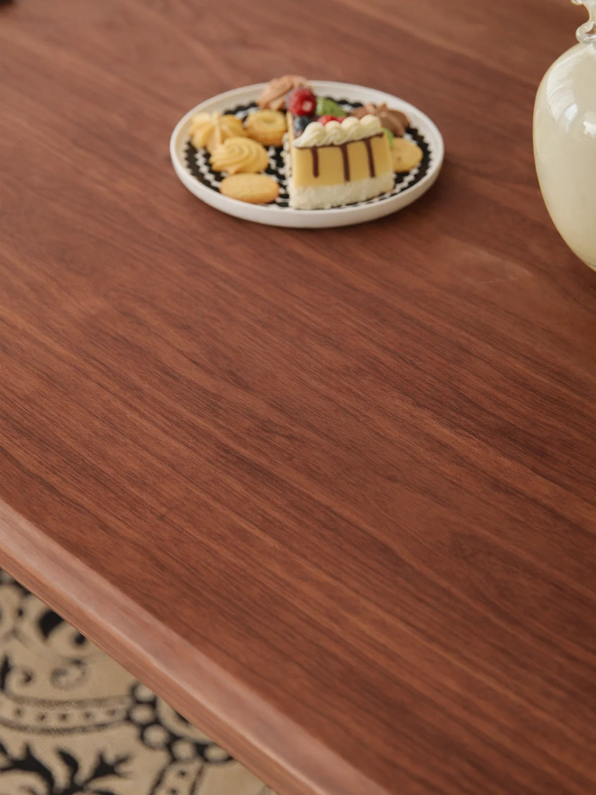 Close-up of the Marlow dining table surface showing natural walnut grain and a softly eased edge.
