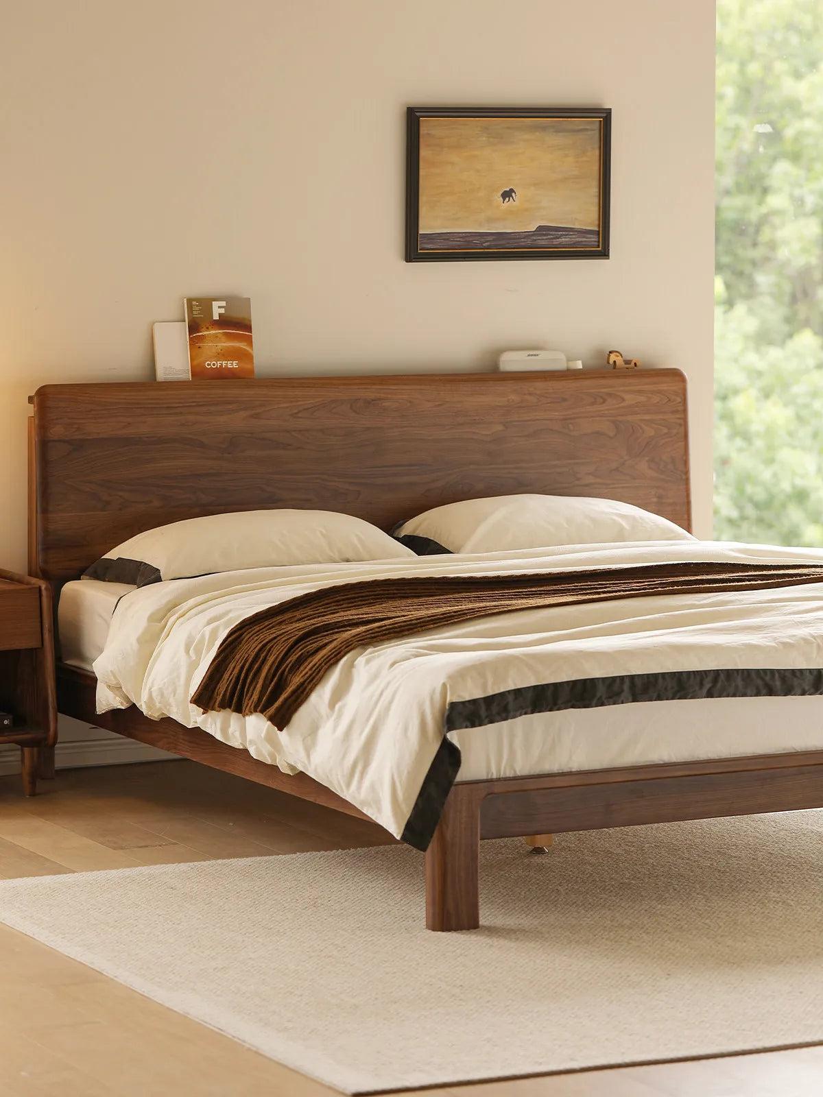 Side angle view from the foot of The Haven mid century modern bed, showing its sturdy mattress platform and elegant proportions.