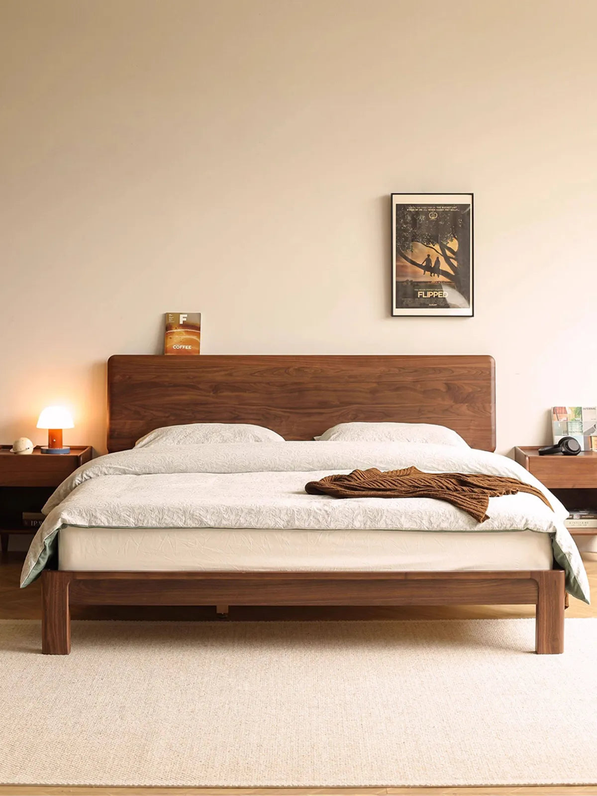Front view of The Haven mid century modern king bed frame by Walnutry, crafted from solid North American Black Walnut, styled in a warm, minimalist bedroom.
