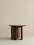 Clean front view of the Cumberland mid century modern round side table, showcasing its solid wood construction and elegant vertical support.