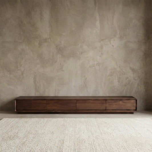 Sleek and minimalist low-profile TV stand crafted from solid North American black walnut, featuring a clean, handleless design and rich natural wood grain.