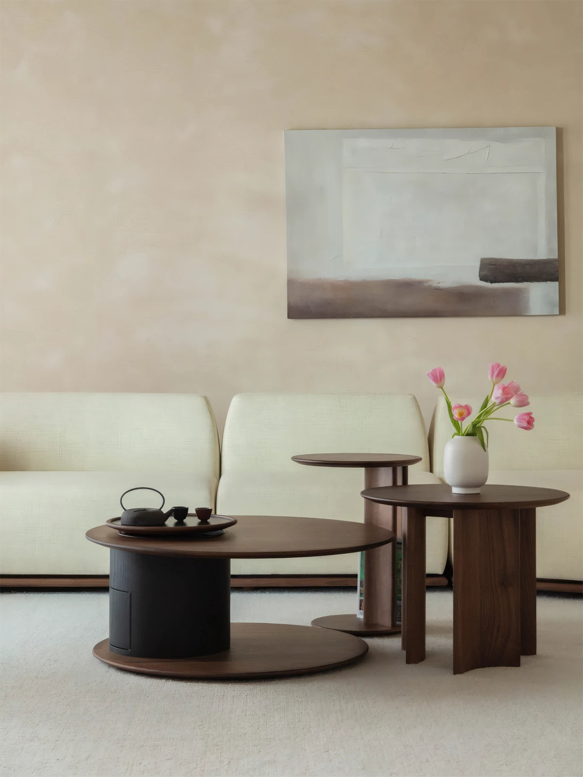 Two different sizes of the modern mid century side table paired together to form a layered nesting arrangement in a cozy space.