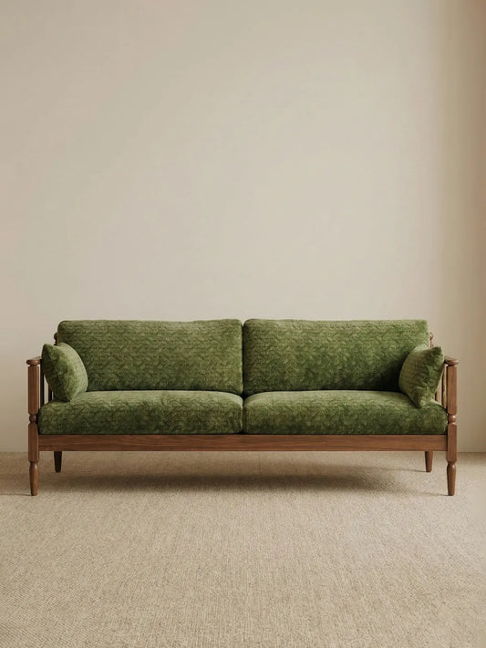 Full front view of the Morris Solid Black Walnut Sofa featuring plush green velvet down-filled cushions and a minimalist solid wood frame.